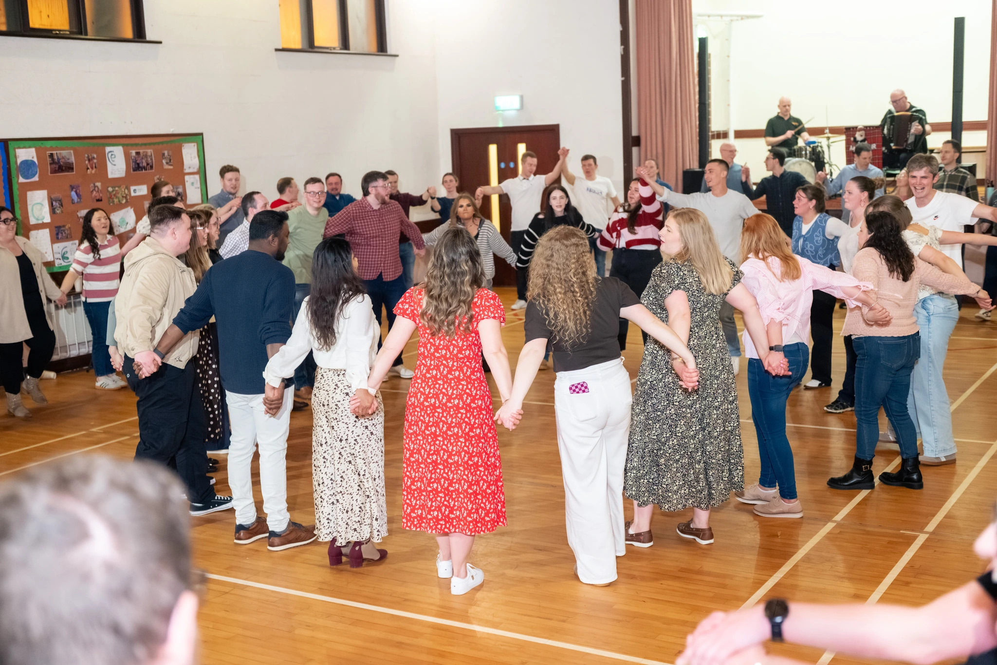 a group of people dancing in a gymnasium