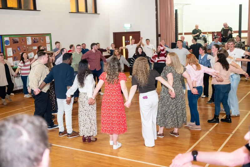 a group of people dancing in a gymnasium