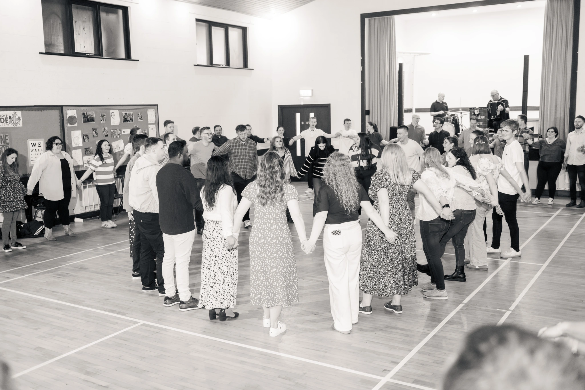 a group of people holding hands in a gymnasium