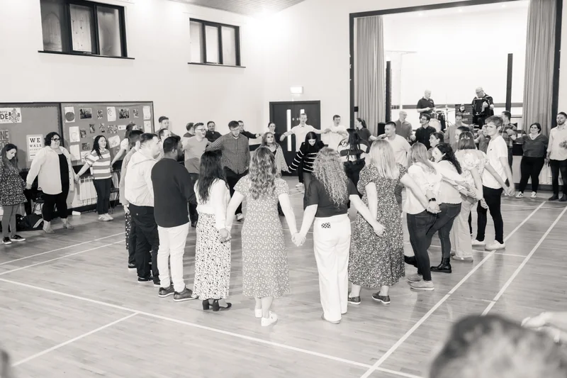 a group of people holding hands in a gymnasium