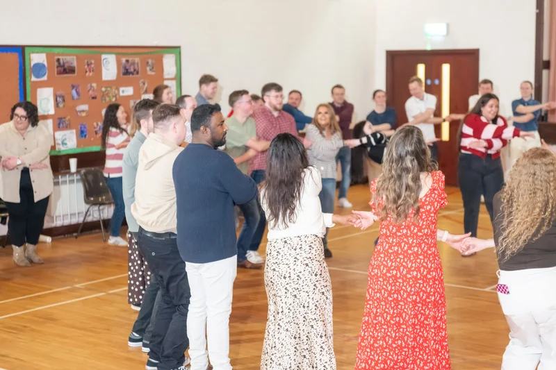 a group of people dancing in a circle