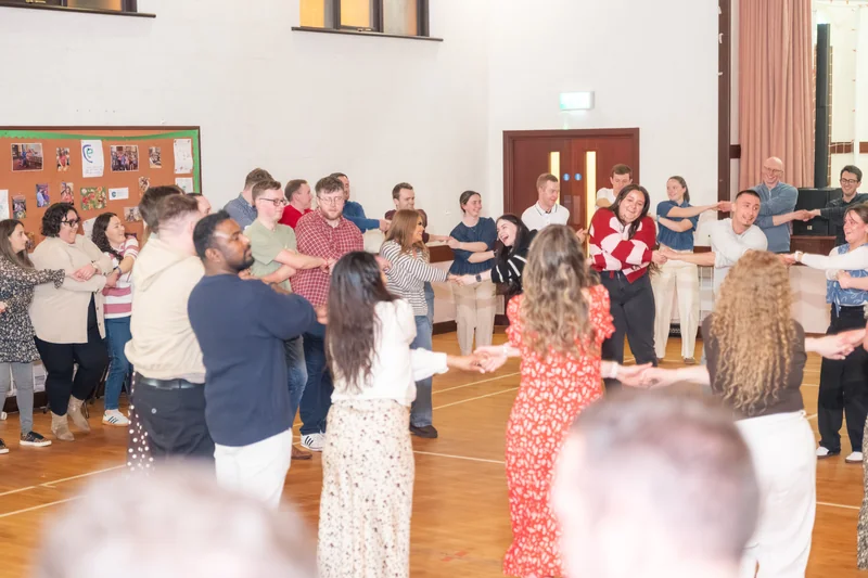 a group of people dancing in a circle