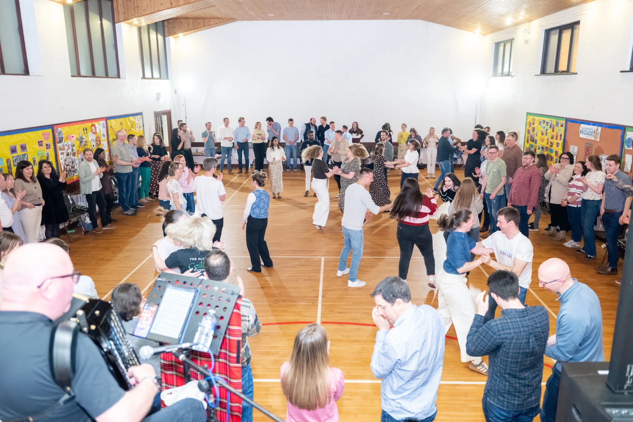 a group of people dancing in a gymnasium