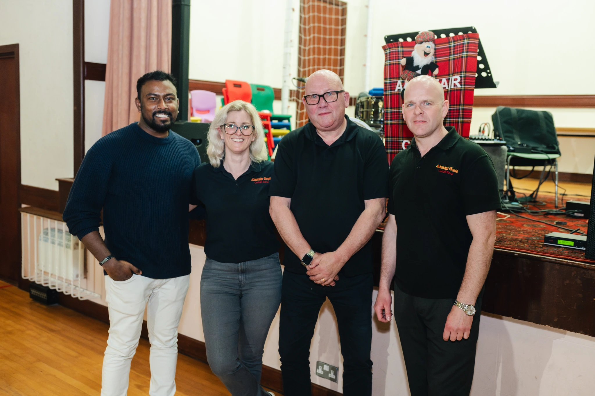 a group of people standing next to each other in a room