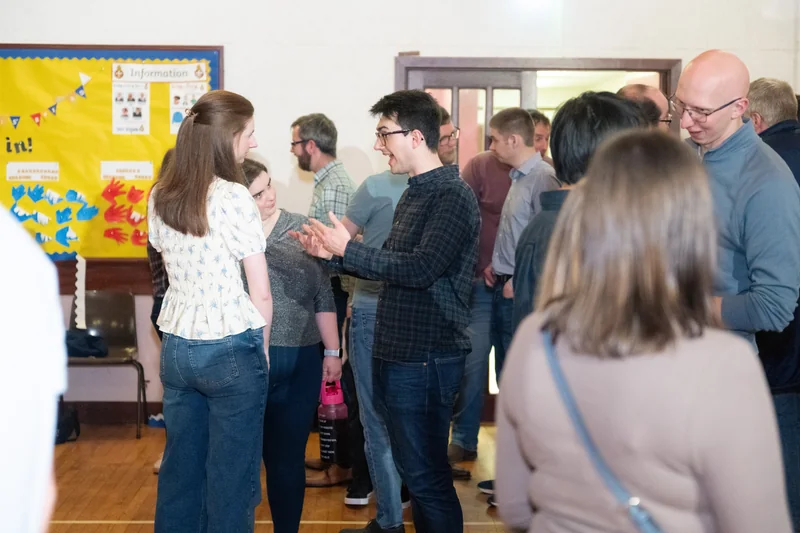 a group of people standing in front of a poster
