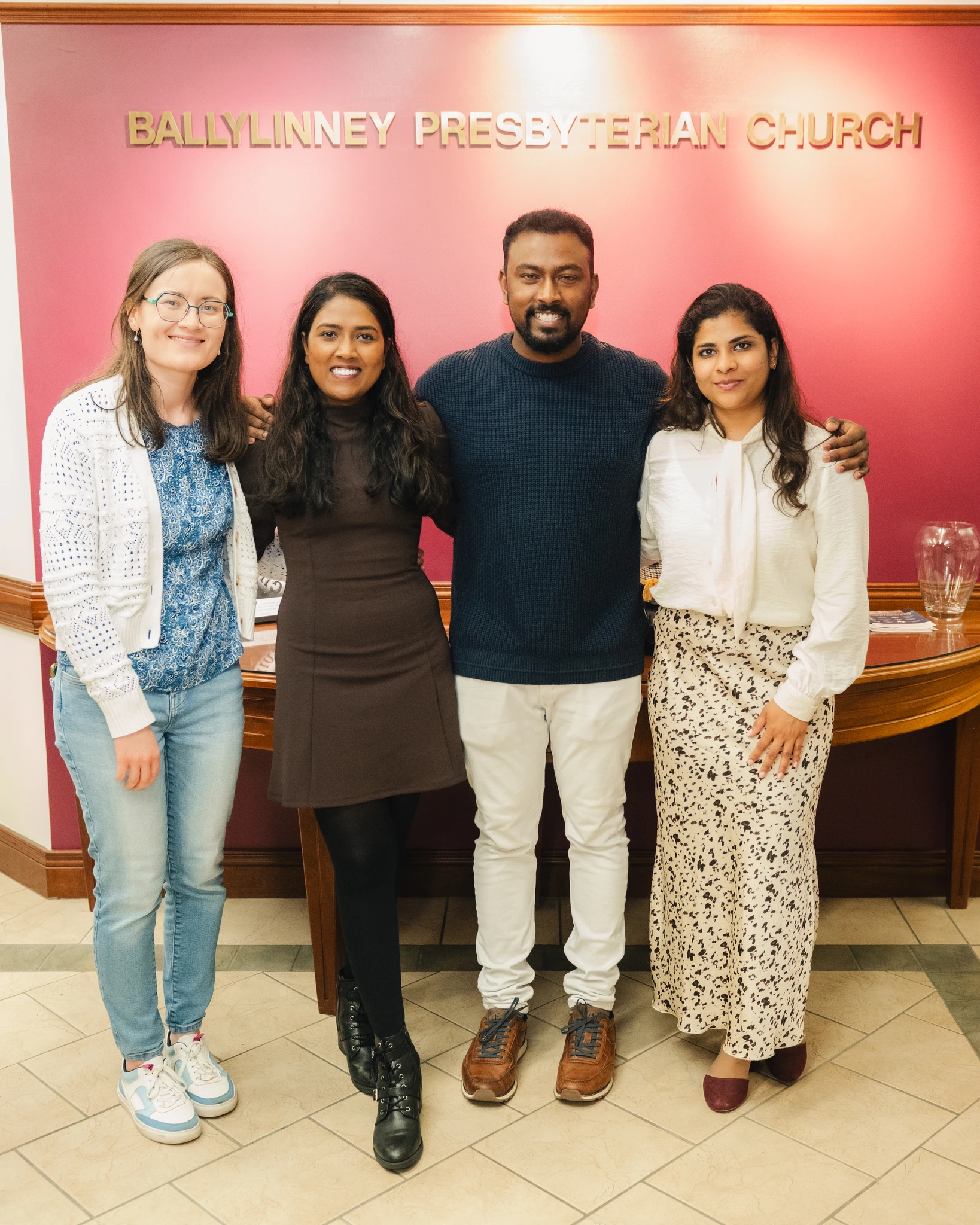 a group of people standing in front of a sign