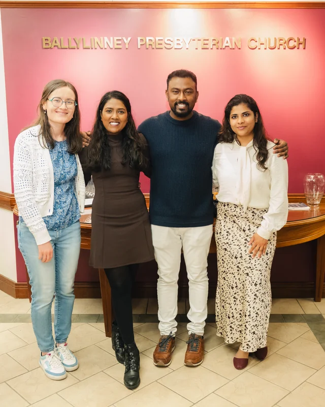 a group of people standing in front of a sign