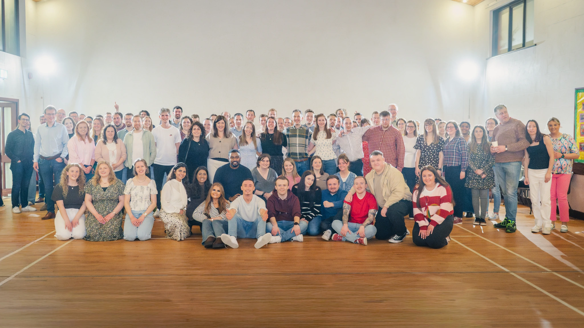 a group of people posing for a photo in a room