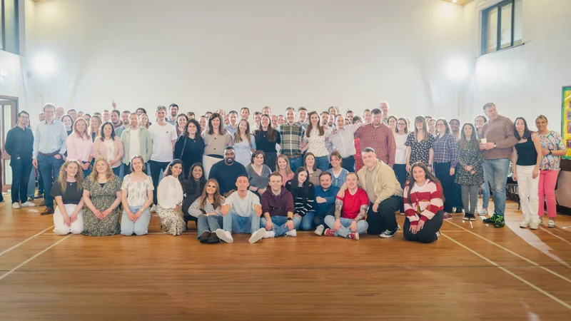 a group of people posing for a photo in a room