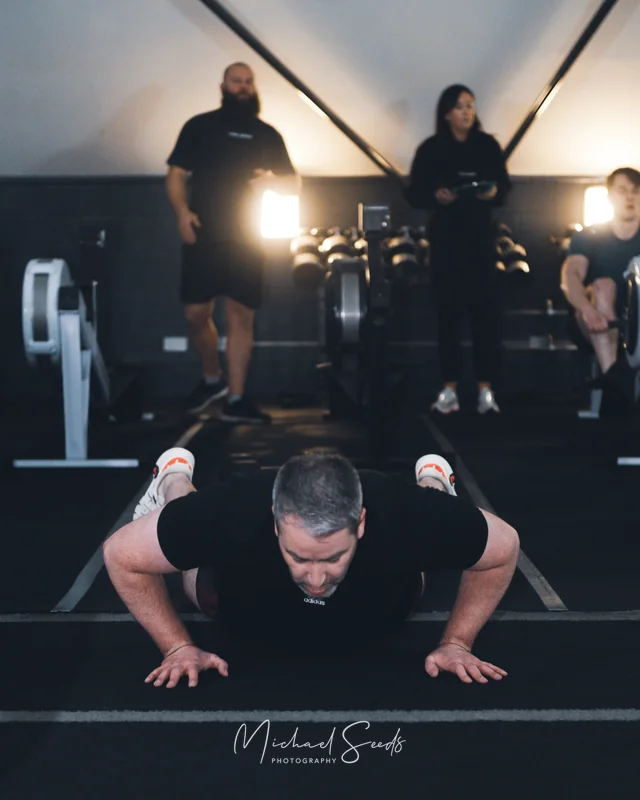 a man doing push ups in a gym
