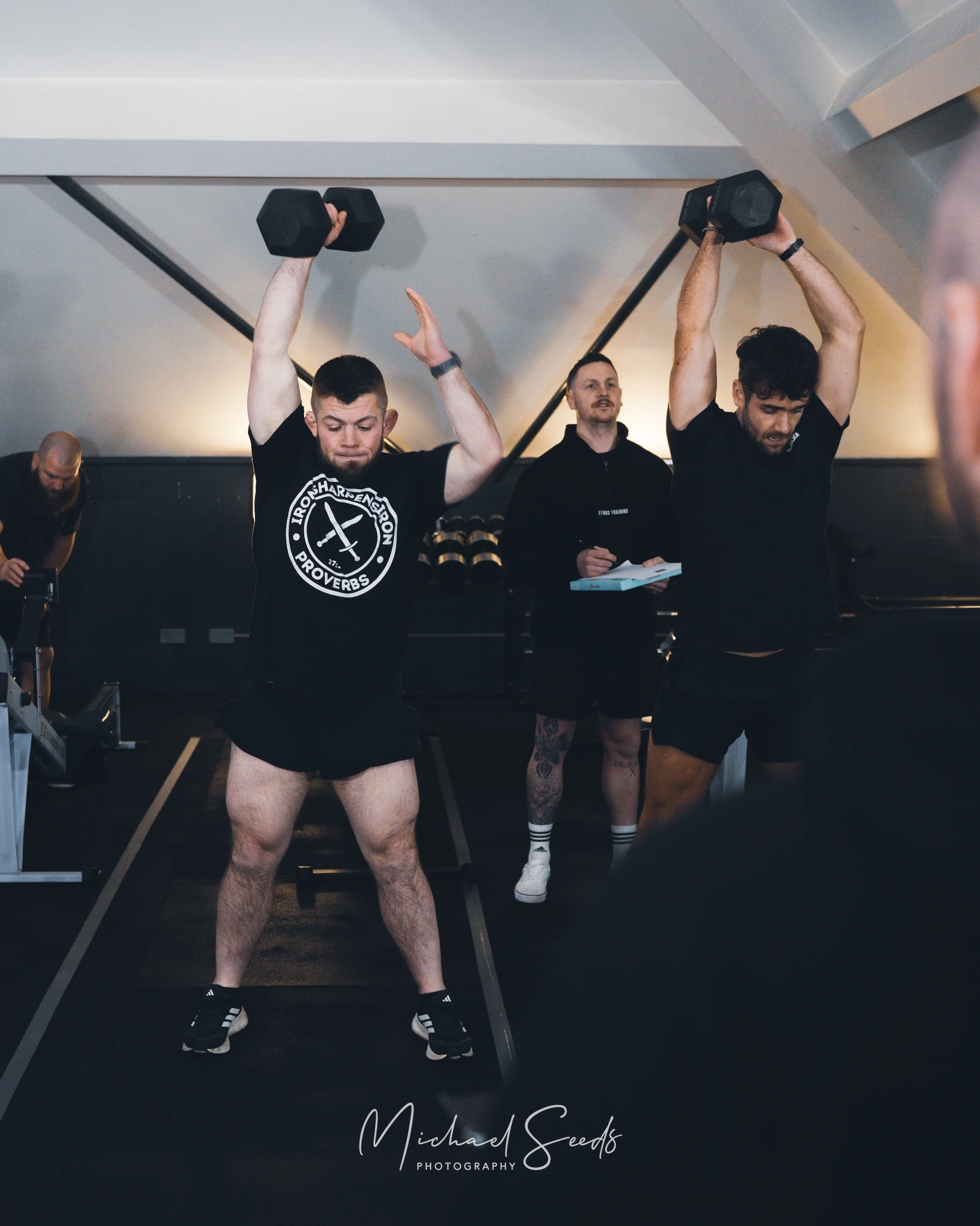 a group of men lifting weights in a gym