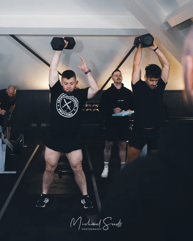 a group of men lifting weights in a gym