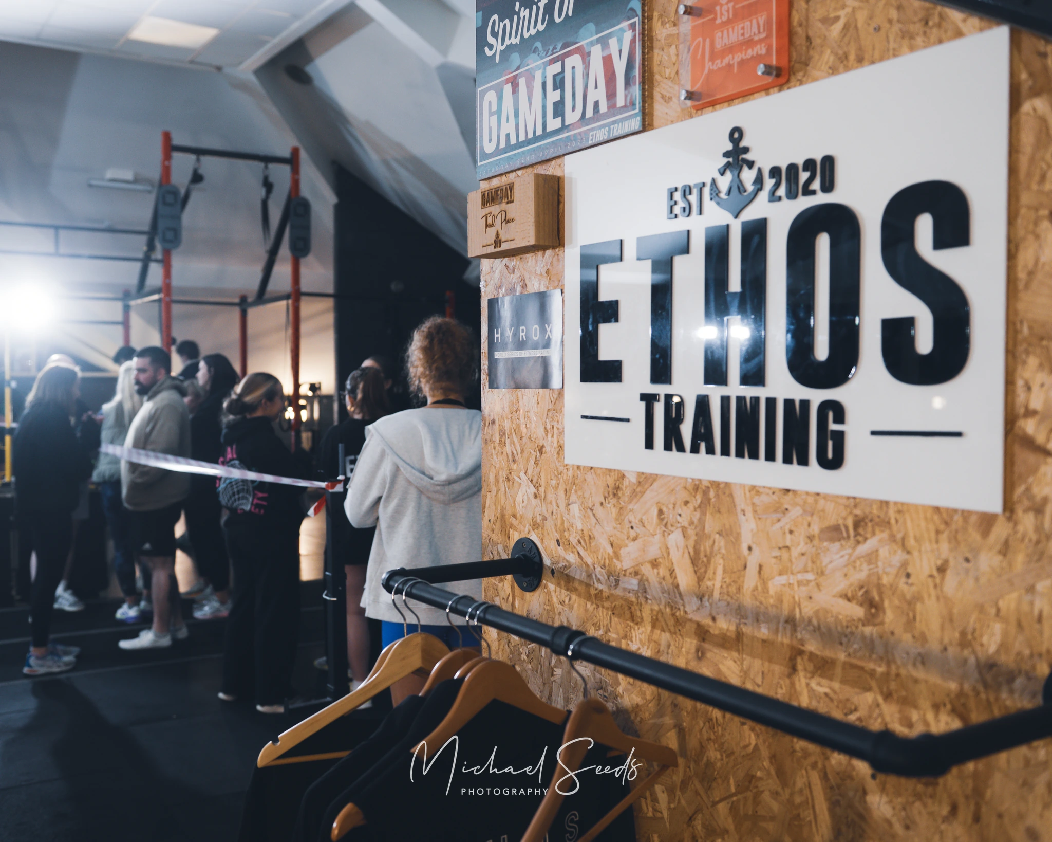 a group of people standing in front of a sign that says ethos training