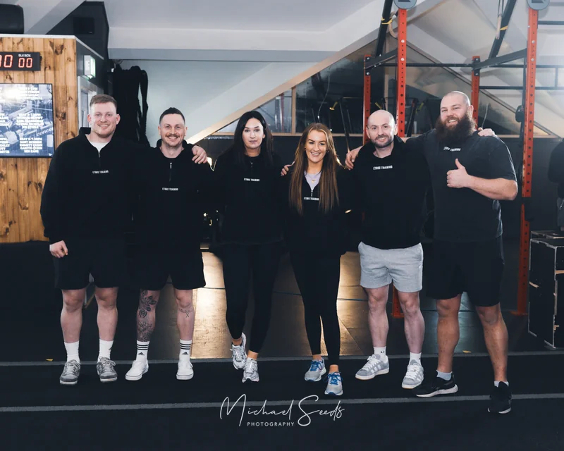 a group of people posing in a gym