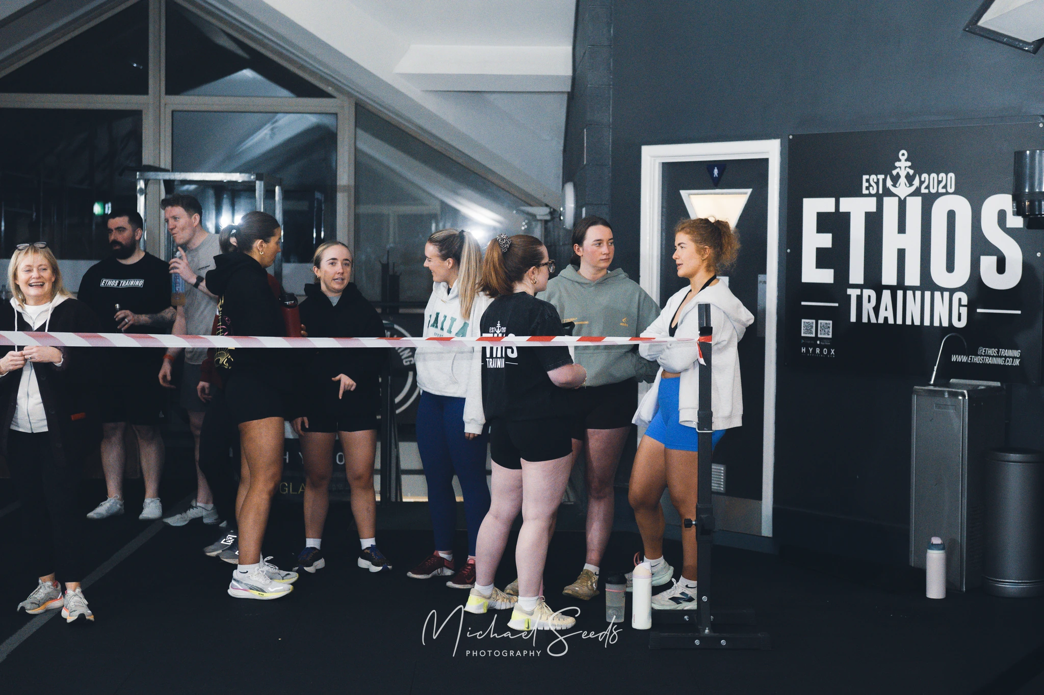 a group of people standing in front of a sign saying ethos training