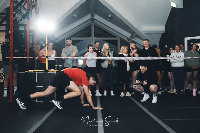 a man doing a gymnastics routine in front of a crowd of spectators