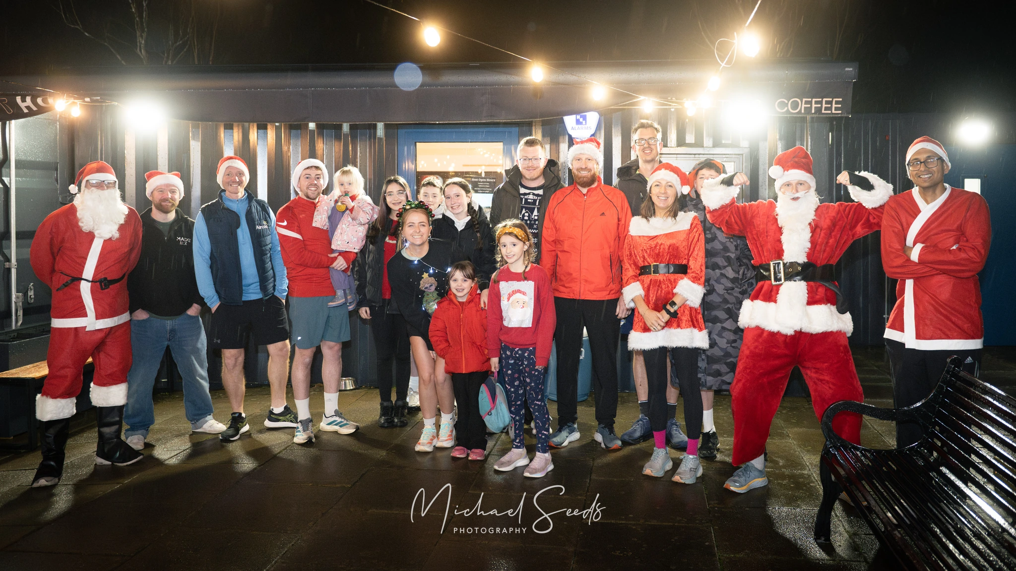 a group of people dressed up in santa claus costumes pose for a photo