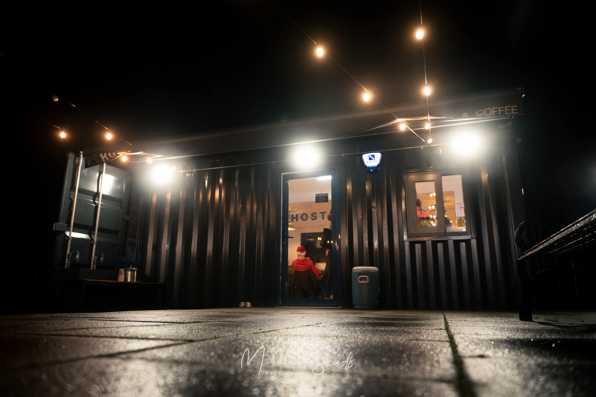a black and white image of a shipping container with lights on the side