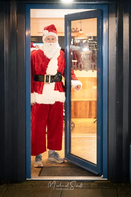 santa claus standing in front of a door