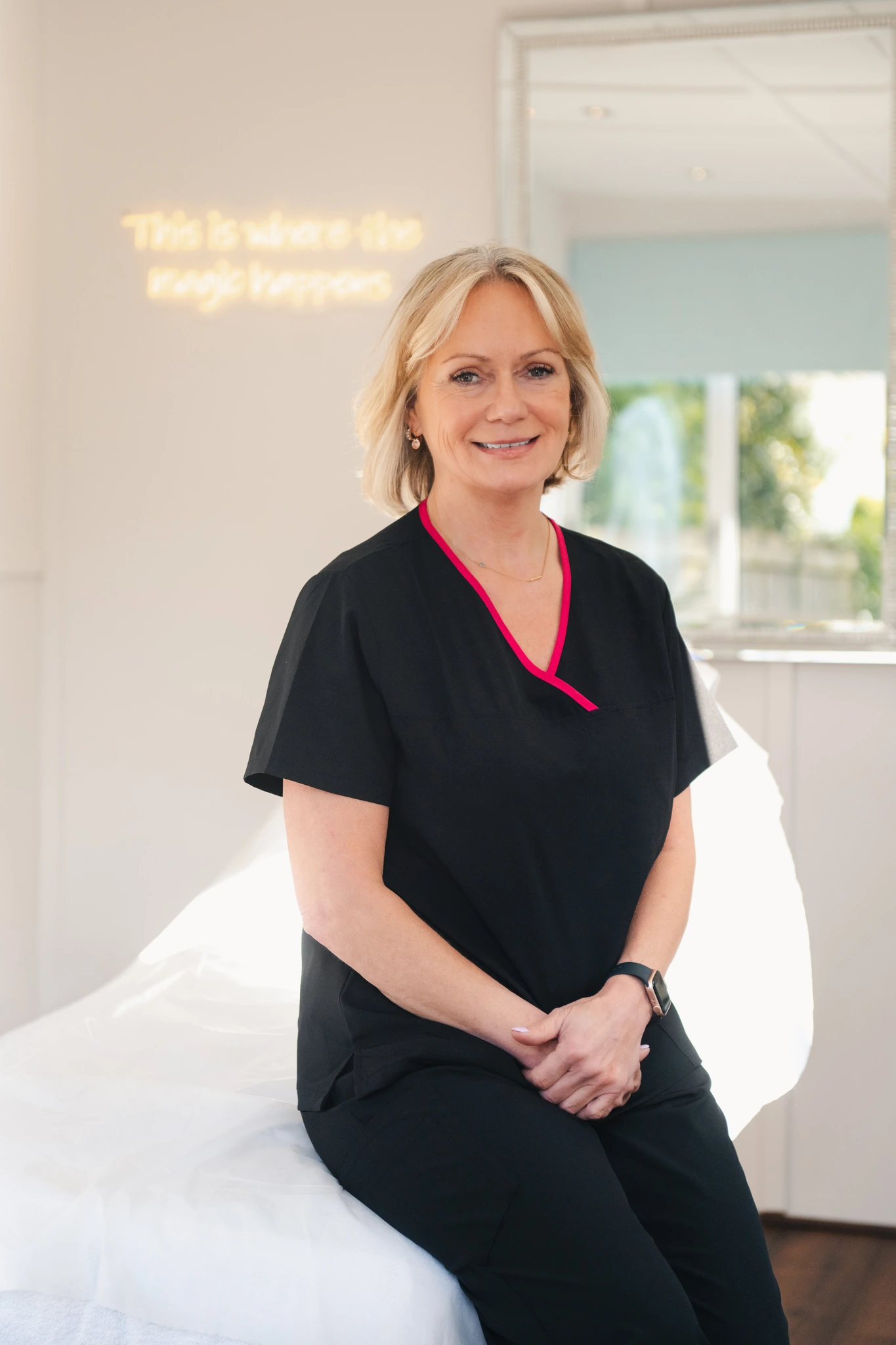 a woman sitting on a bed in a medical room