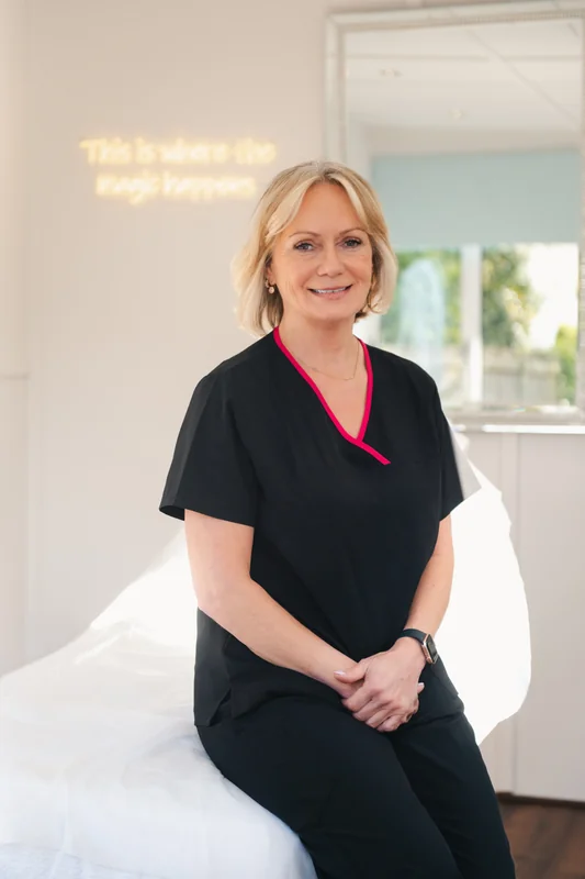 a woman sitting on a bed in a medical room