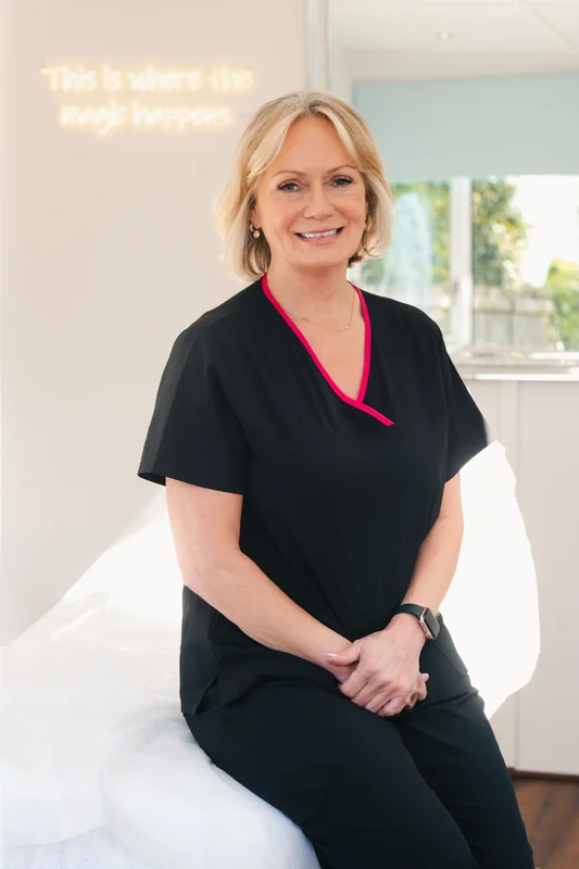 a woman sitting on a bed in a room