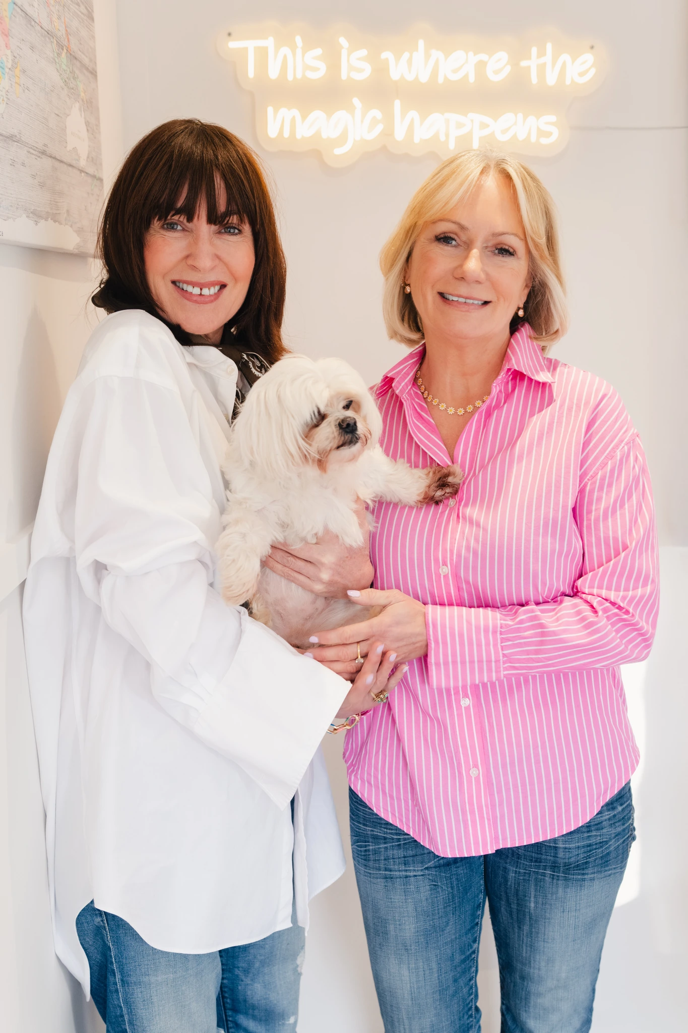 a woman with a dog and a sign that says this is where the magic happens
