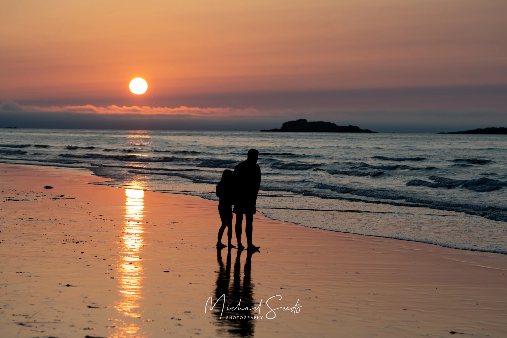 Evening light washes the coast in soft amber tones. The waves slow, the sky fades, and the reflections linger—capturing the gentle calm of the North Coast of Ireland at day’s end.