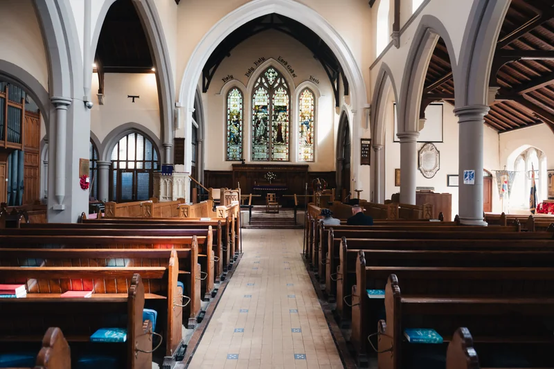 a view of the inside of a church with stained glass windows
