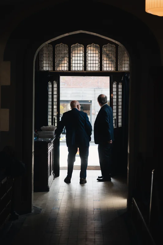 two men standing in the doorway of a church