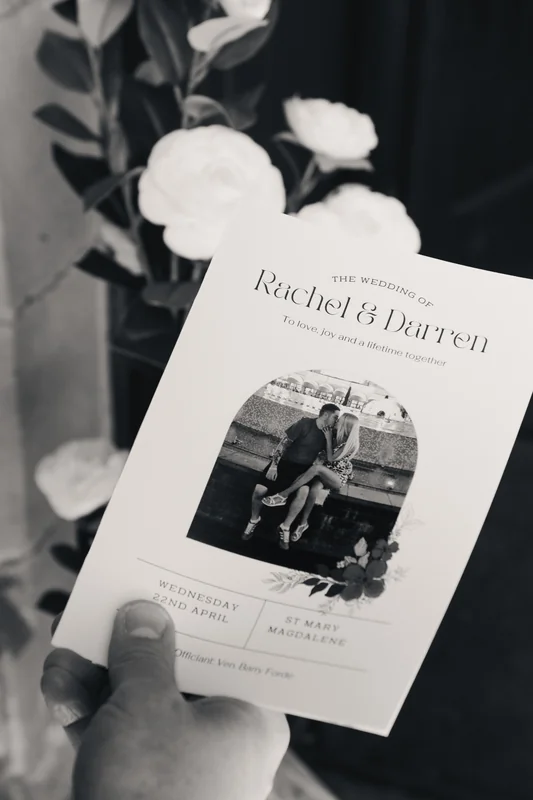 a black and white wedding invitation with a photo of the bride and groom