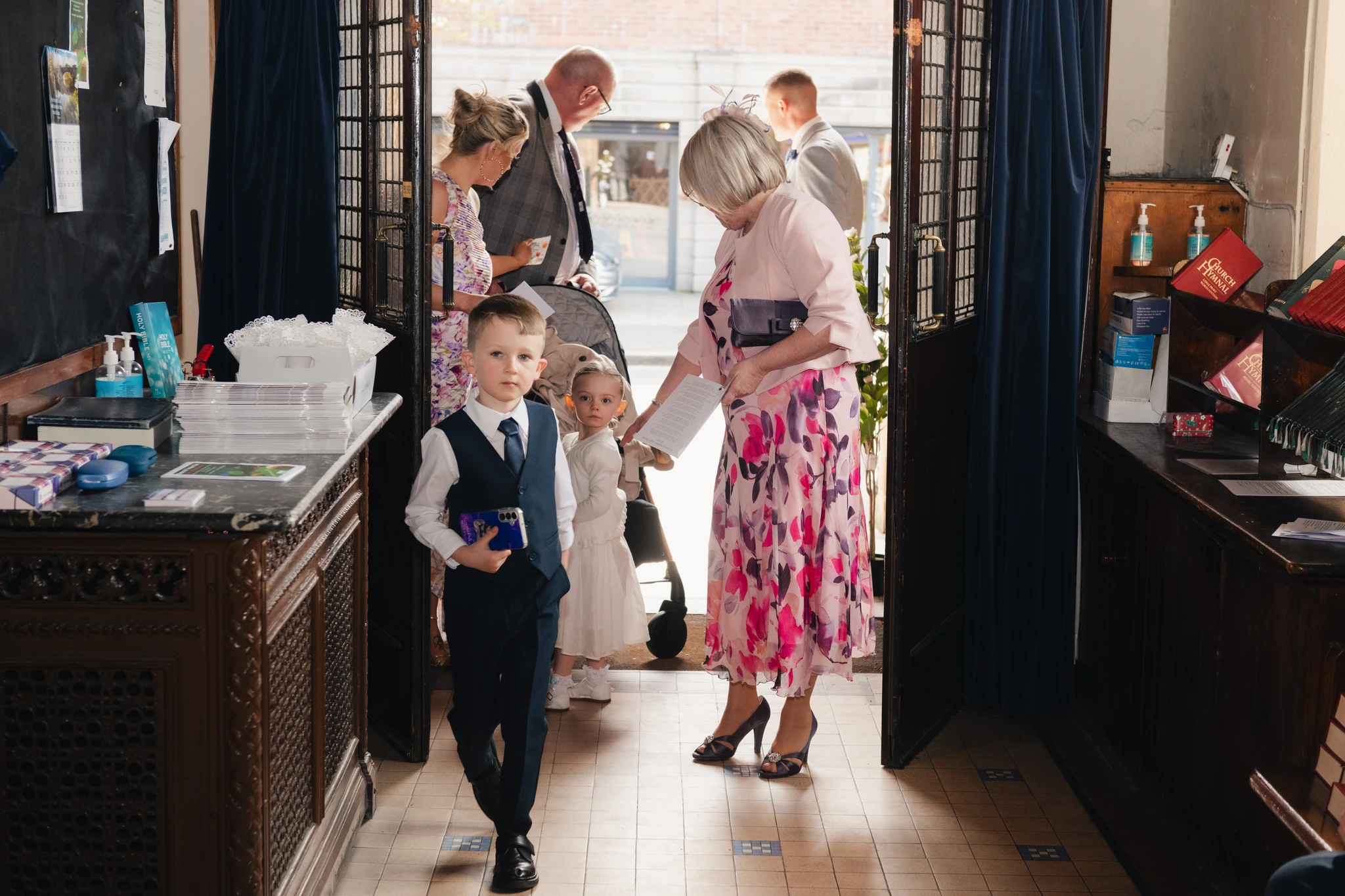 a bride and groom walking down the aisle of a church