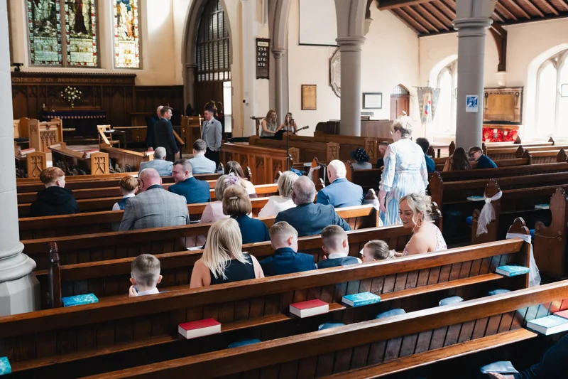 a bride and groom walk down the aisle of a church