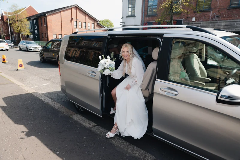 a bride getting out of her mercedes benz van