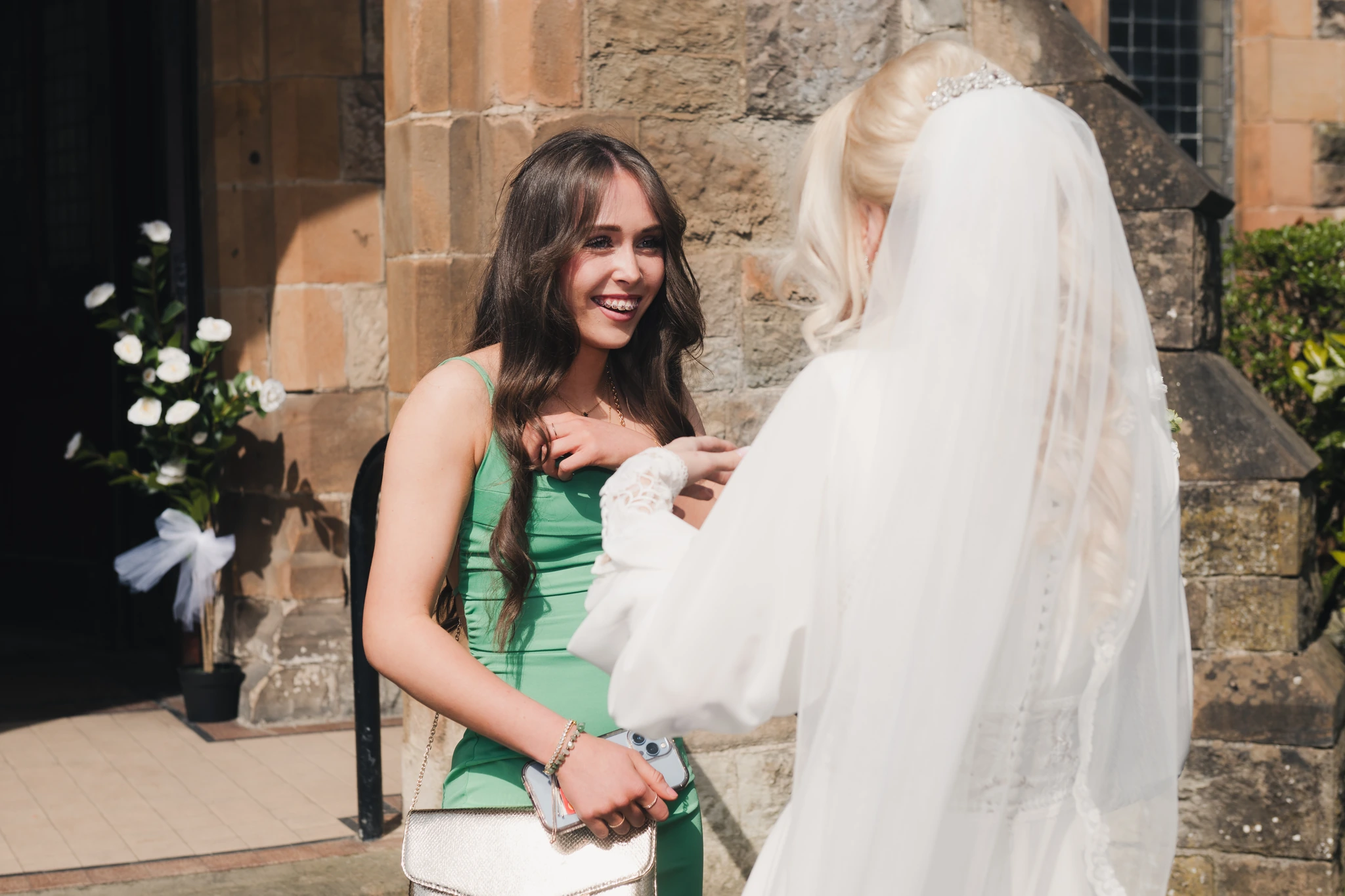 a bride and groom kiss in front of a church