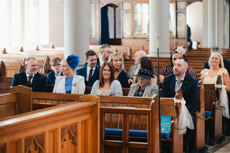 a bride and groom walk down the aisle of a church