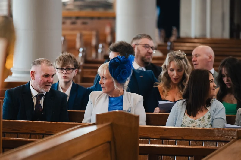 a bride and groom walk down the aisle of a church