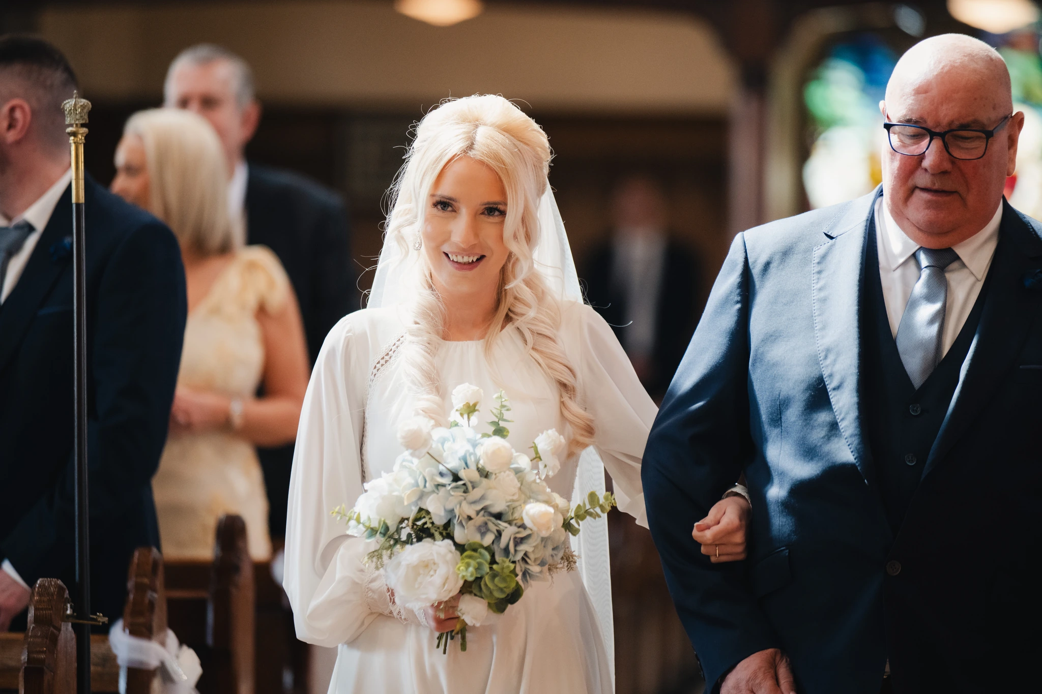 a bride walks down the aisle of a church