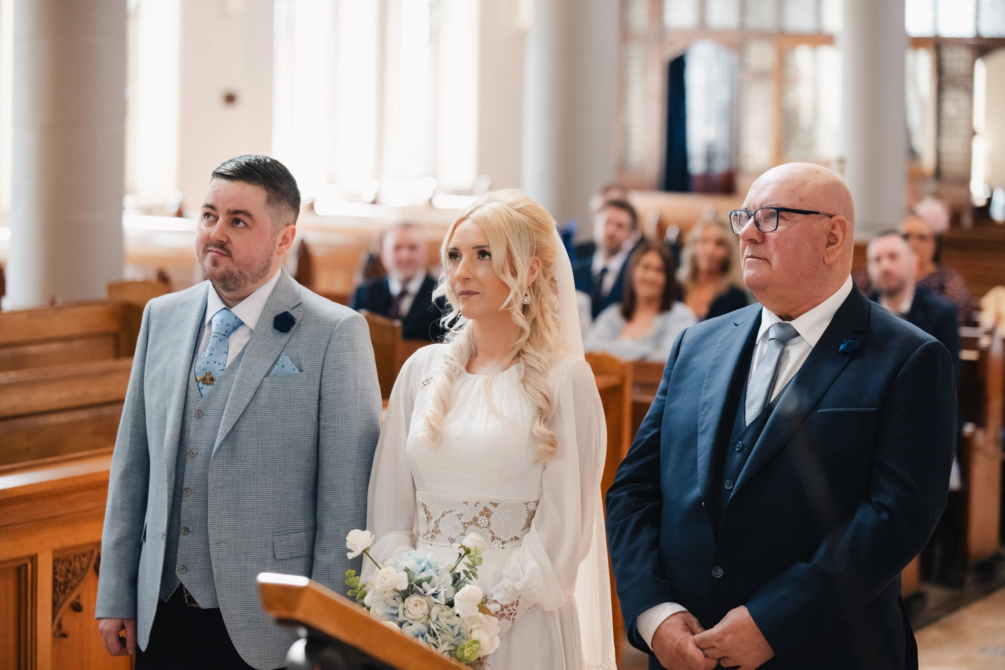 a bride and groom walk down the aisle of a church