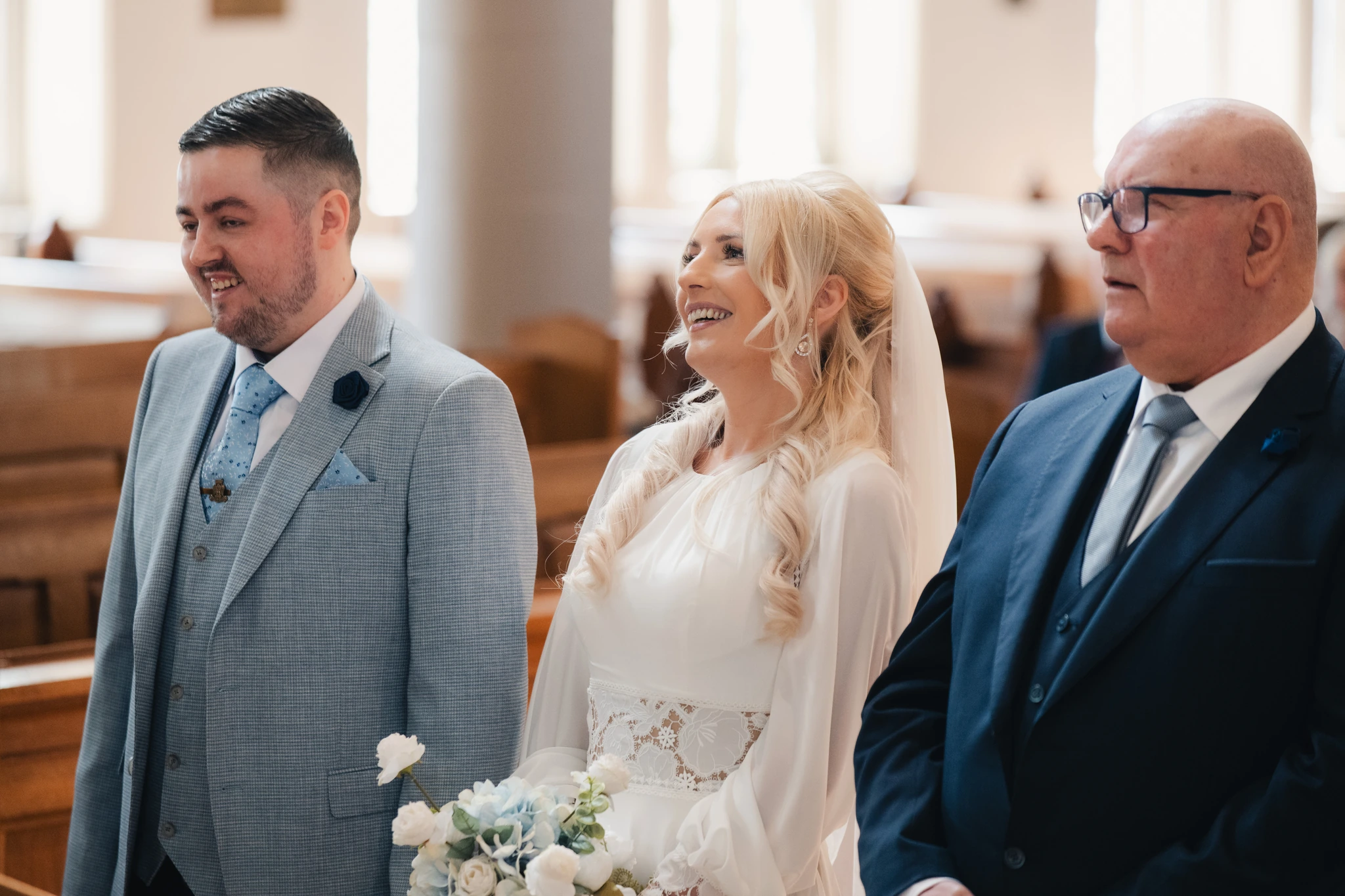 a bride walks down the aisle of a church
