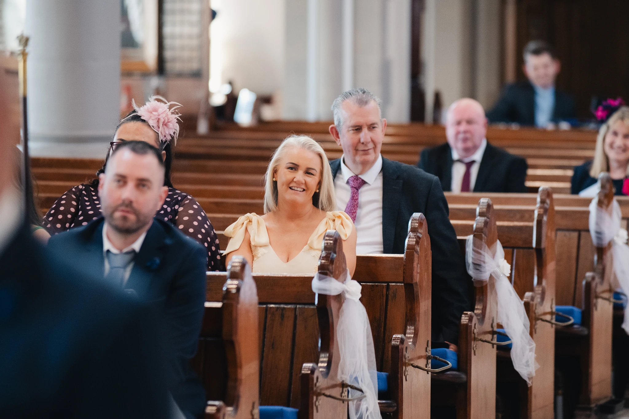 a bride walks down the aisle of a church