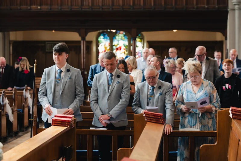 a bride and groom walk down the aisle of a church