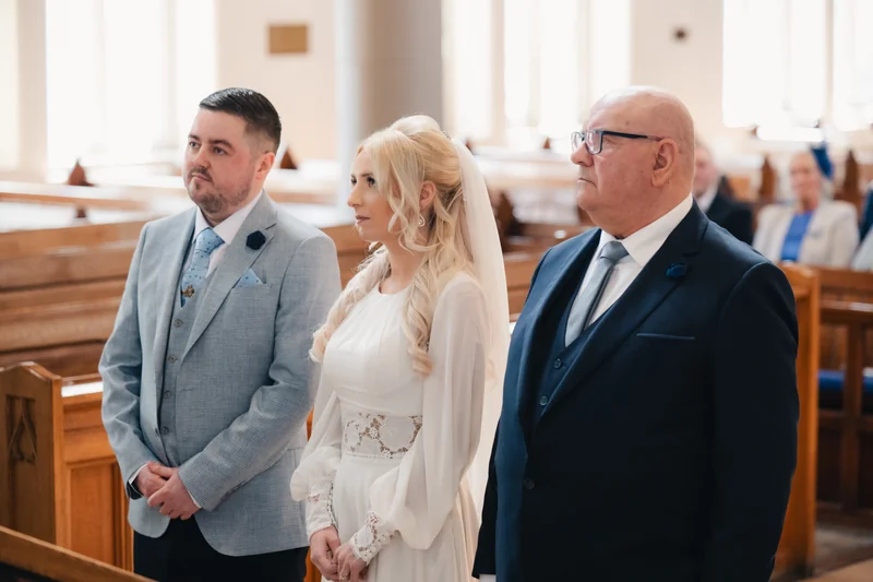 a bride walks down the aisle of a church