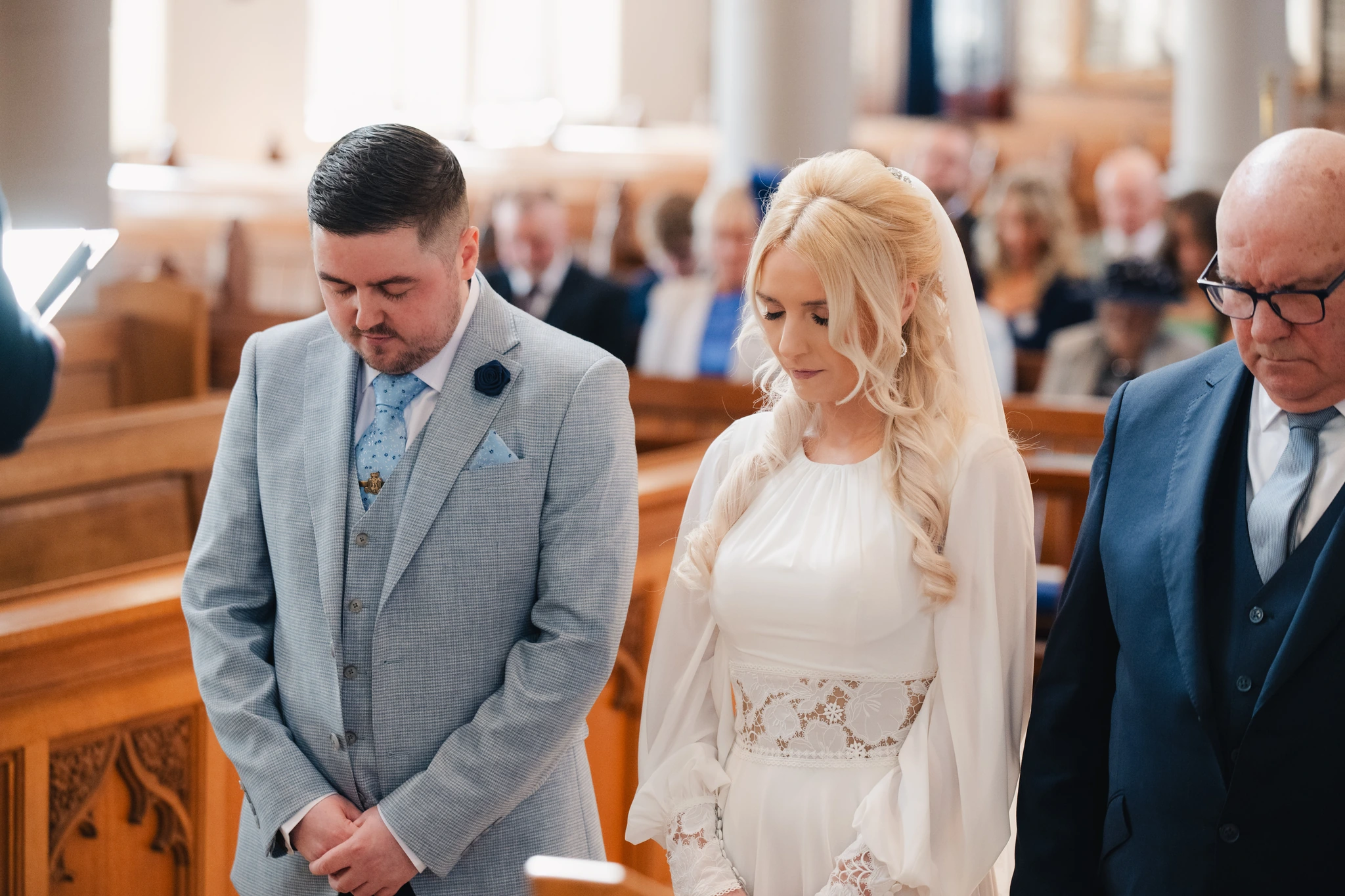 a bride and groom walk down the aisle of a church