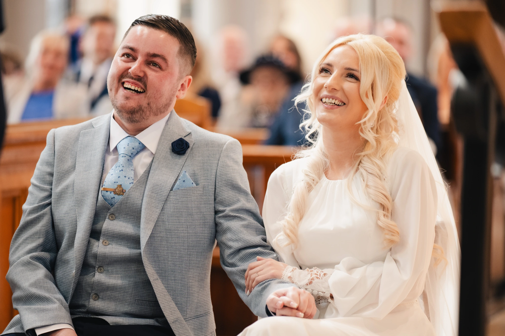 a bride and groom smile at the end of their wedding ceremony