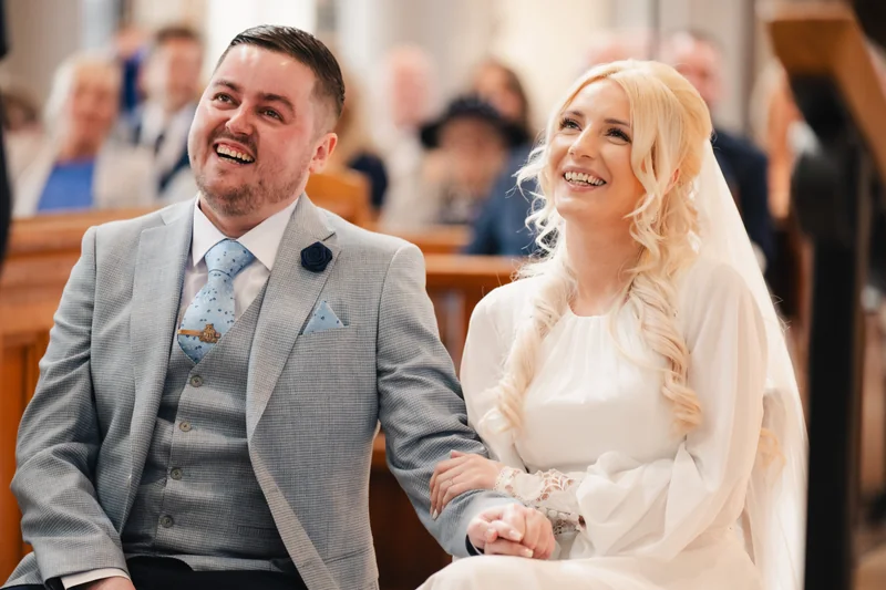 a bride and groom smile at the end of their wedding ceremony