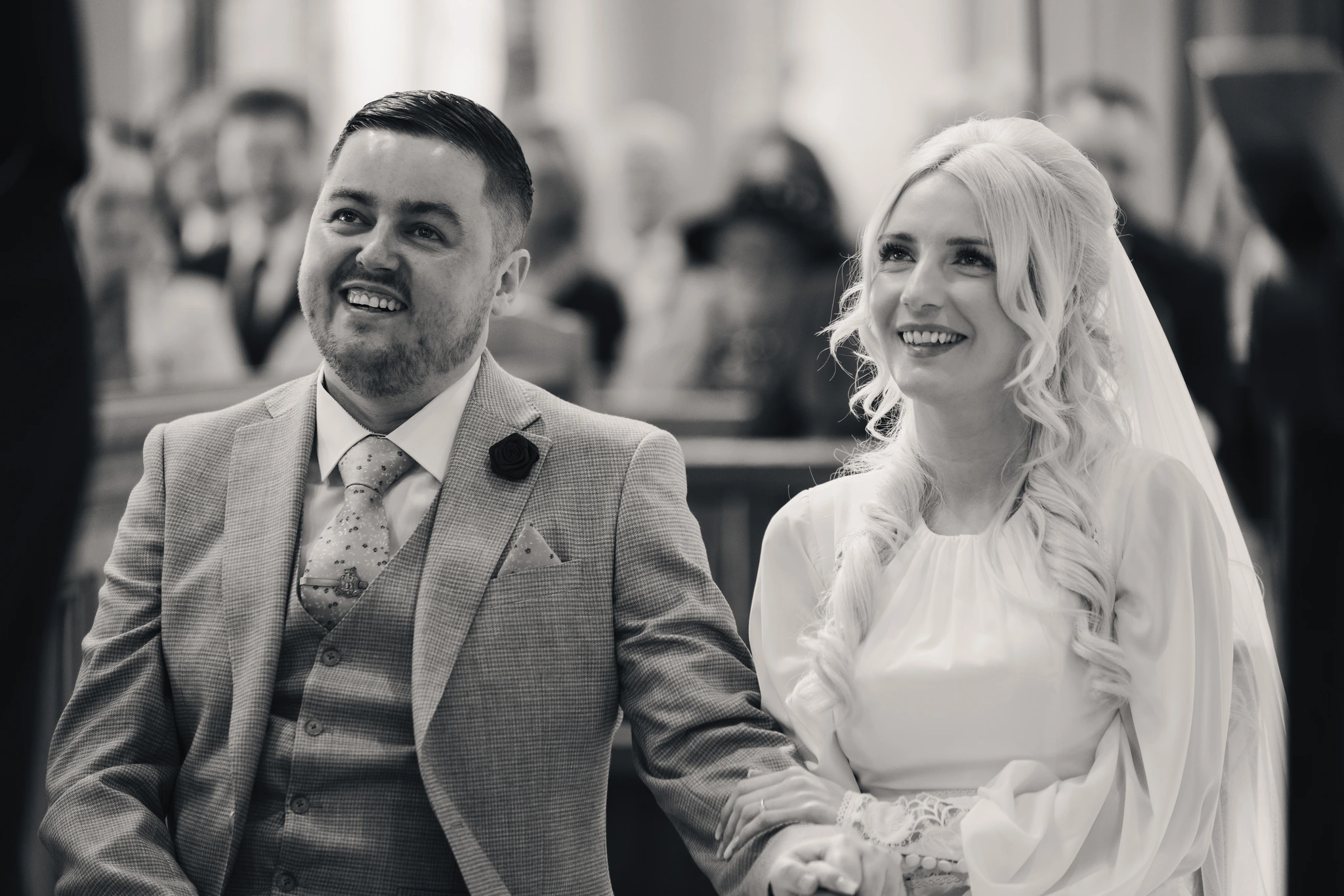 a bride and groom walk down the aisle of a church