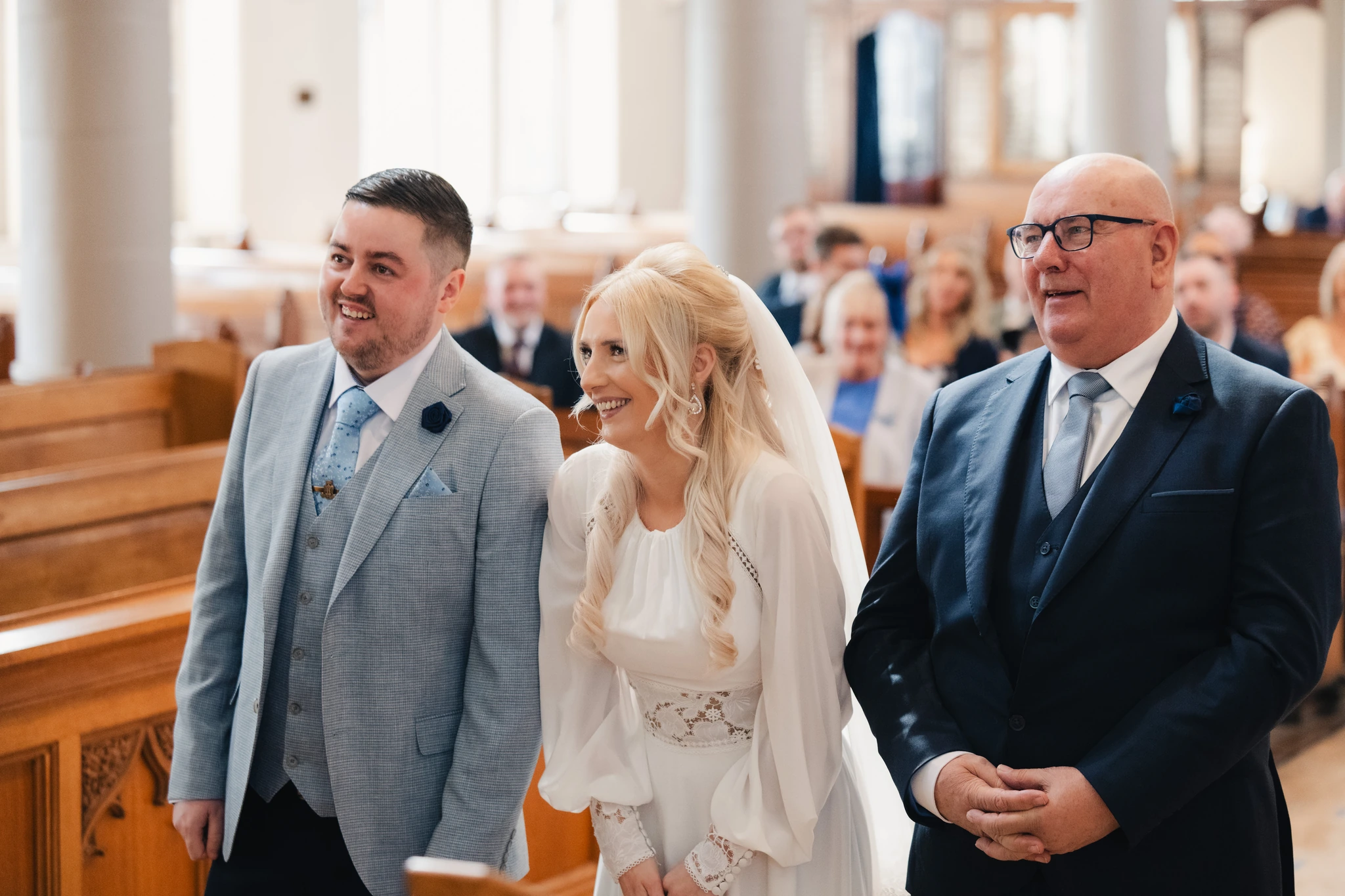 a bride walks down the aisle of a church