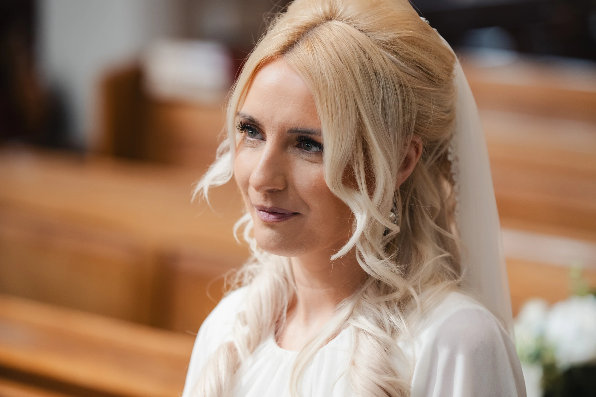 a bride with a veil and veil in a church