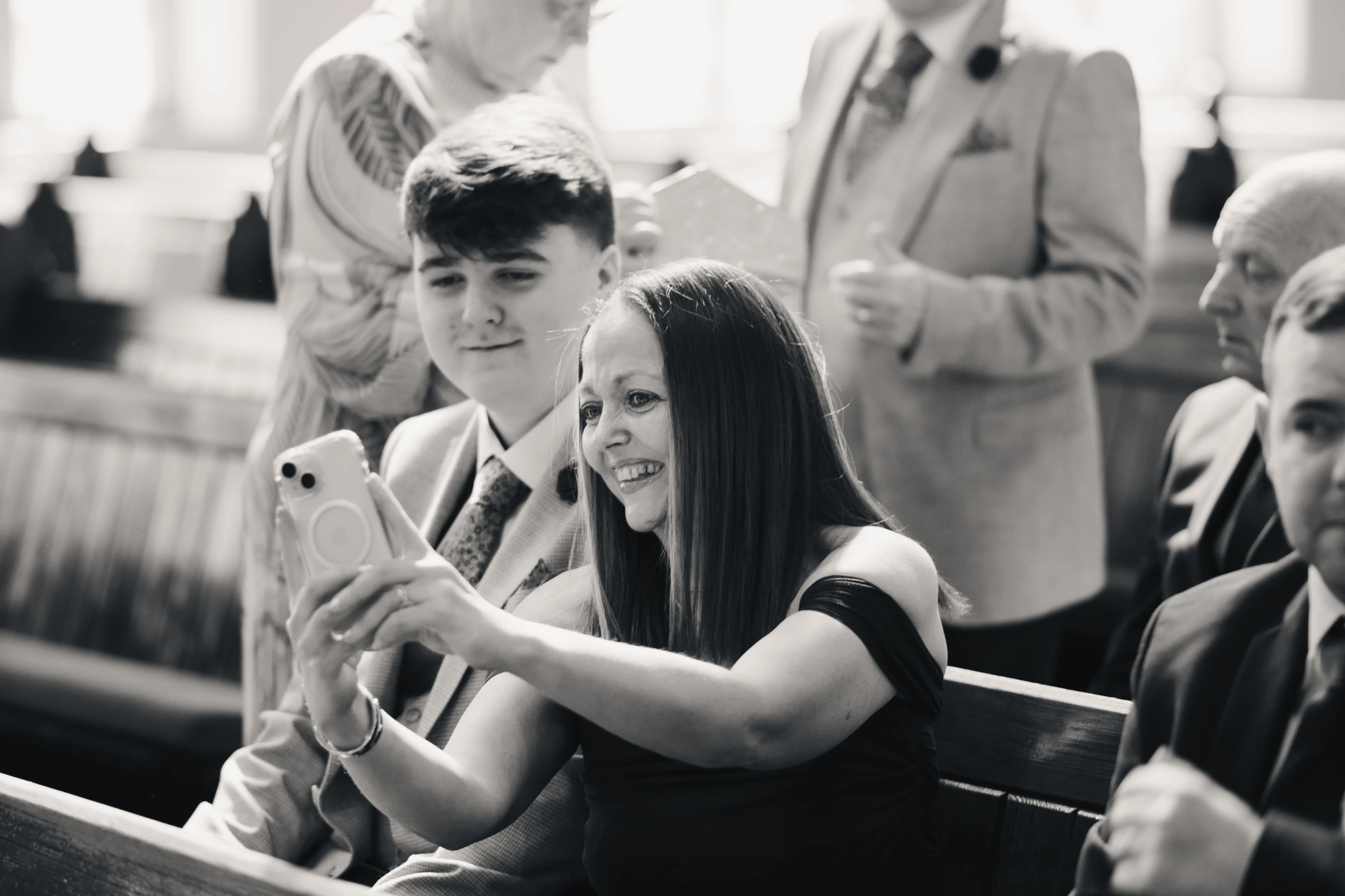 a bride and groom taking a selfie in a church